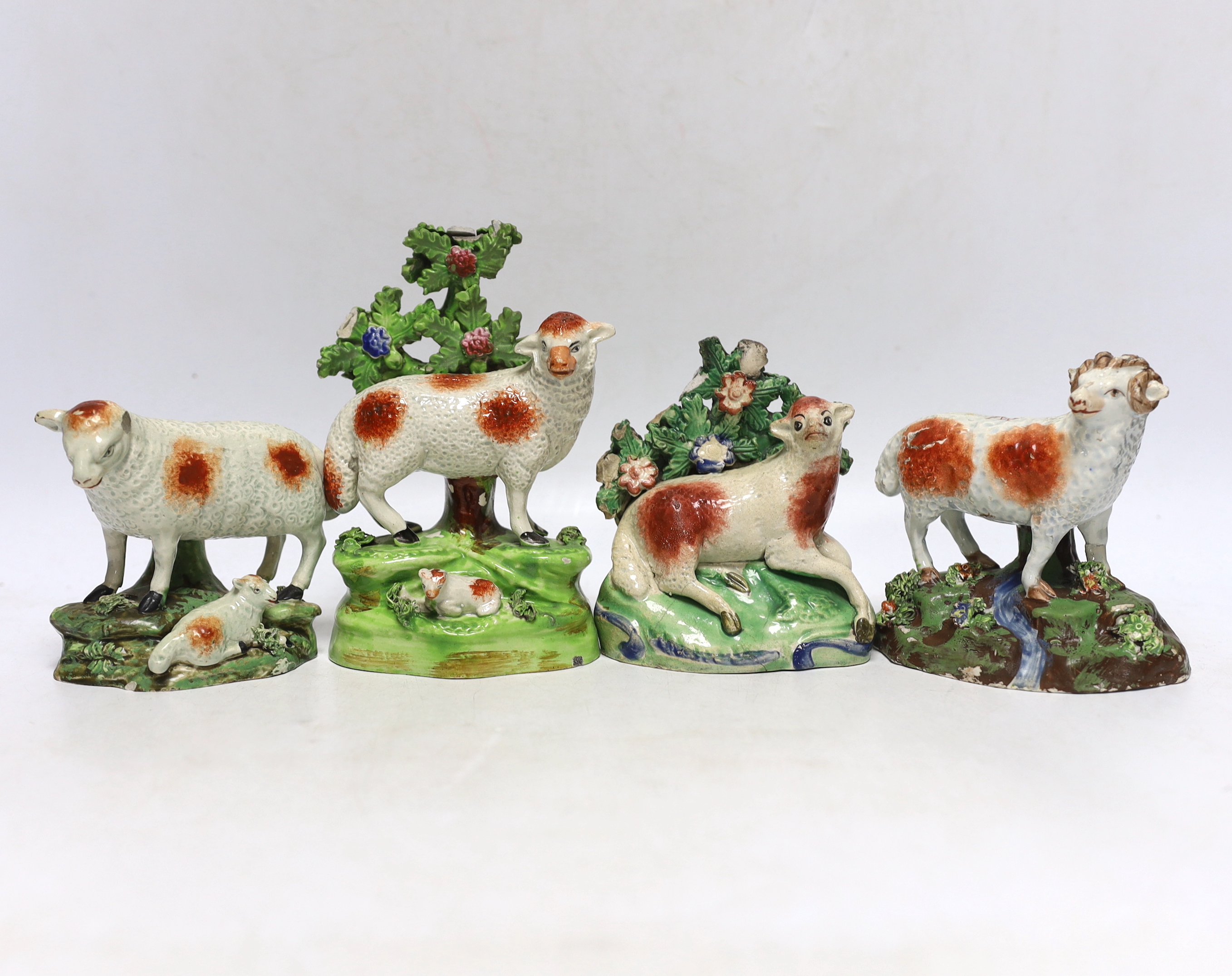 Four Staffordshire pearlware figures of sheep, c.1820-30, one with rare initials ‘PW’ to its back, largest 15cm high